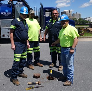 540 Technologies and Capital Region Water workers posing over open water pipe